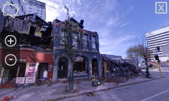 Street view of an earthquake-damaged heritage building in Christchurch with a collapsed facade and rubble